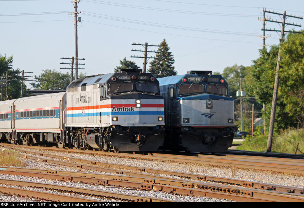 AMTK 406 on the point of EB Hiawatha 340 passes the trailing Cab-bage on WB 339